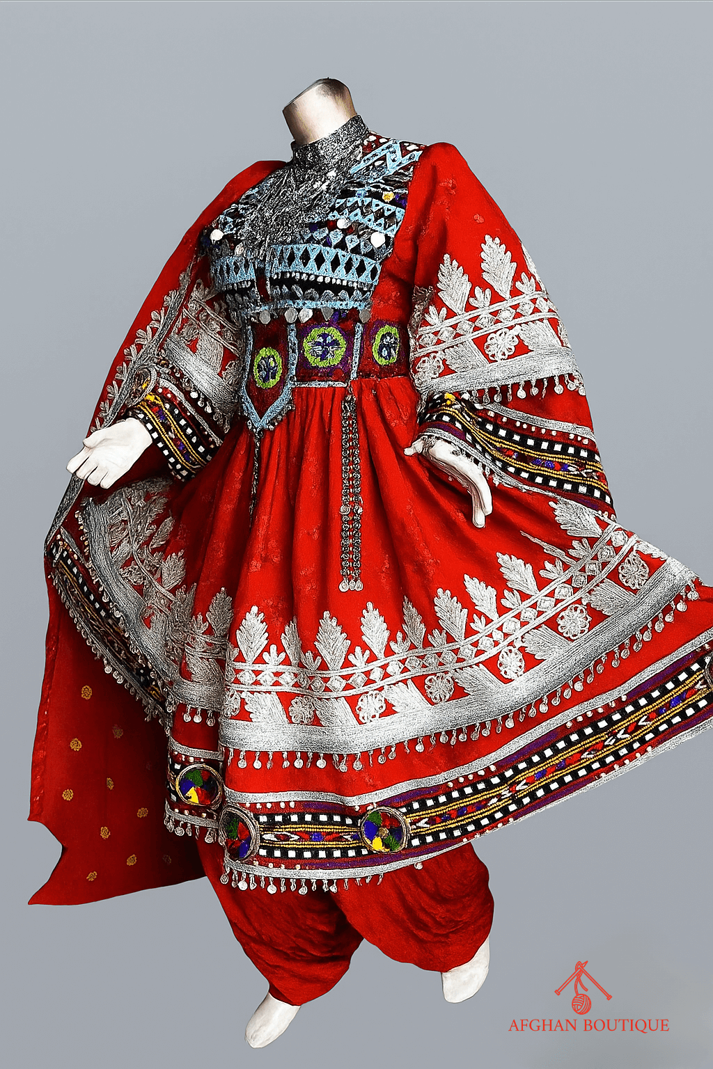 Left view of classic red Afghani frock highlighting fine ethnic detailing