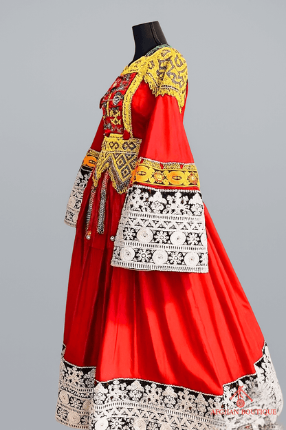 Left view of bright red Afghani frock highlighting traditional hand embroidery