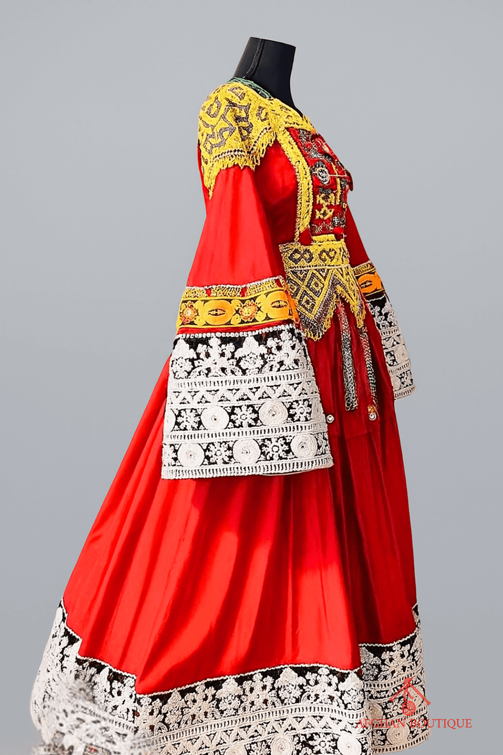 Right side of bright red Afghani frock showing golden stitching
