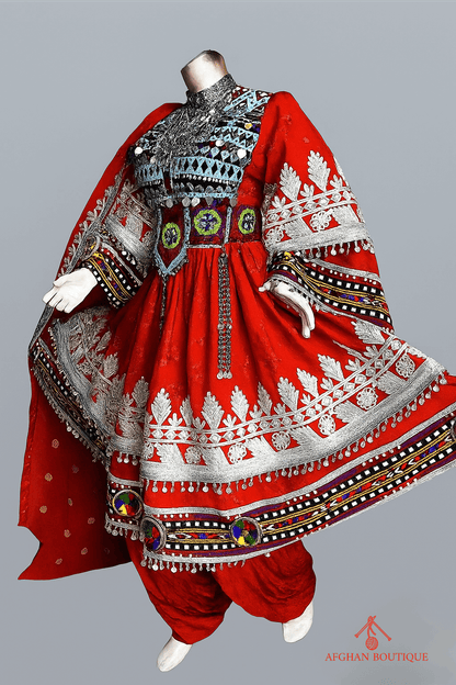 Left view of classic red Afghani frock highlighting fine ethnic detailing