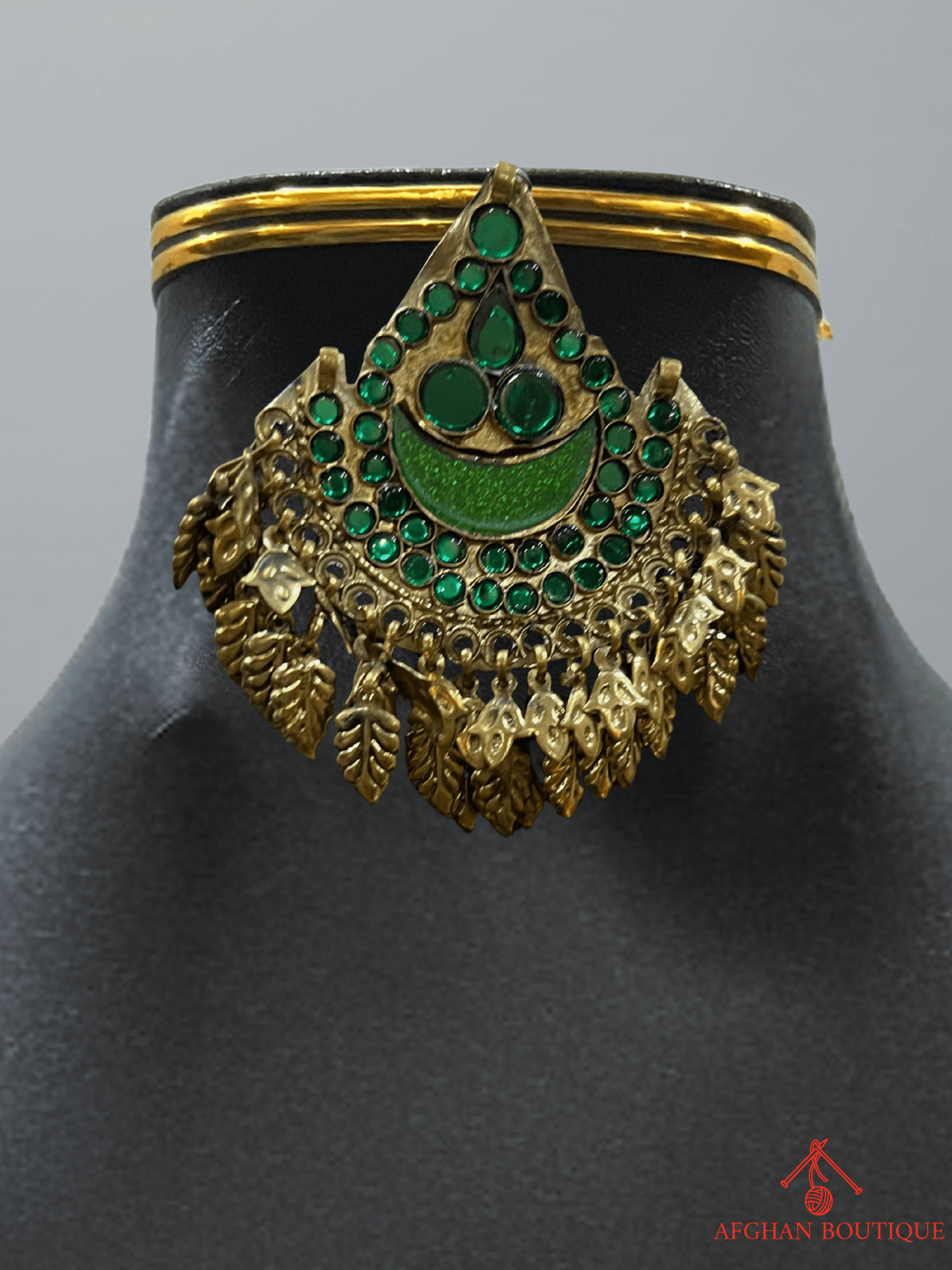 Deep emerald green handcrafted Afghani headpiece close-up