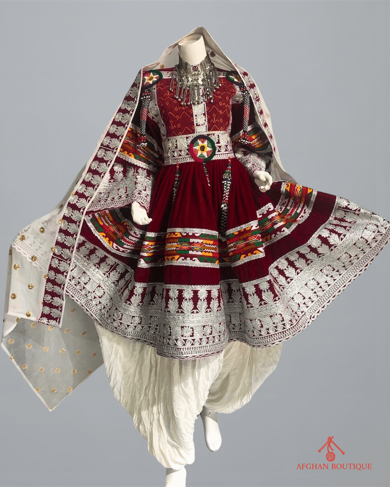 Front view of maroon Afghani frock with silver thread embroidery

