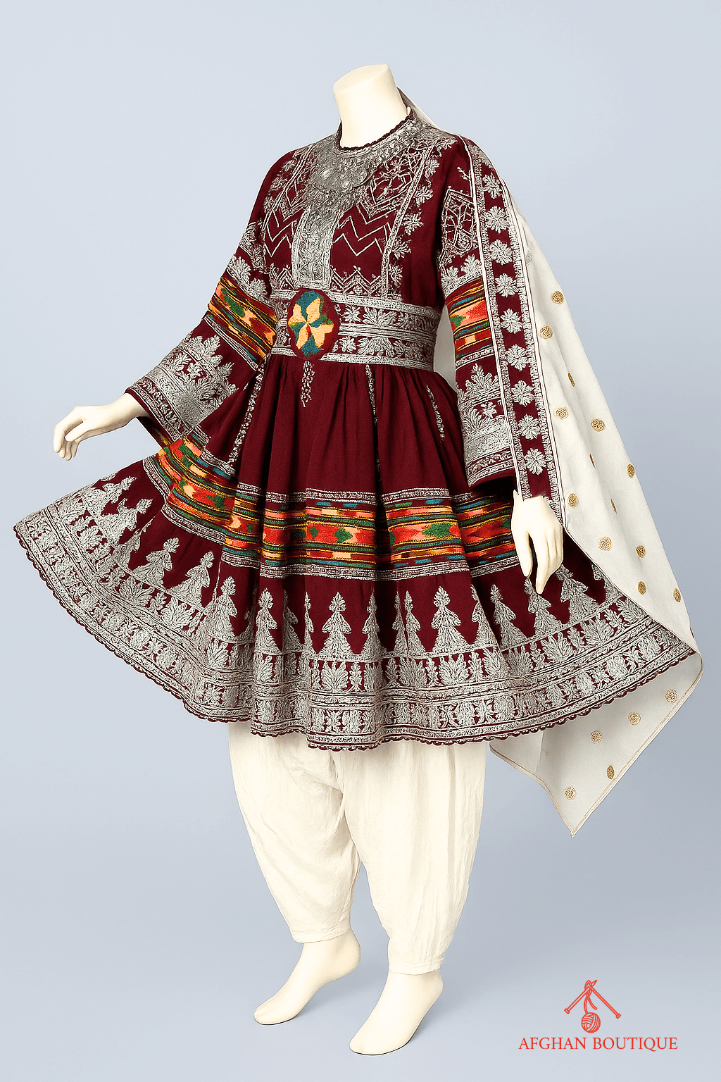Left angle of maroon Afghani frock displaying delicate embroidery work
