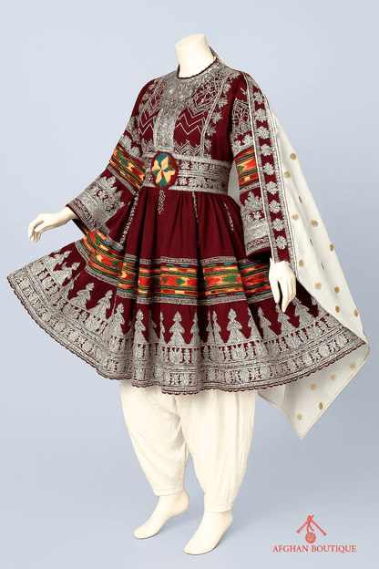 Left angle of maroon Afghani frock displaying delicate embroidery work