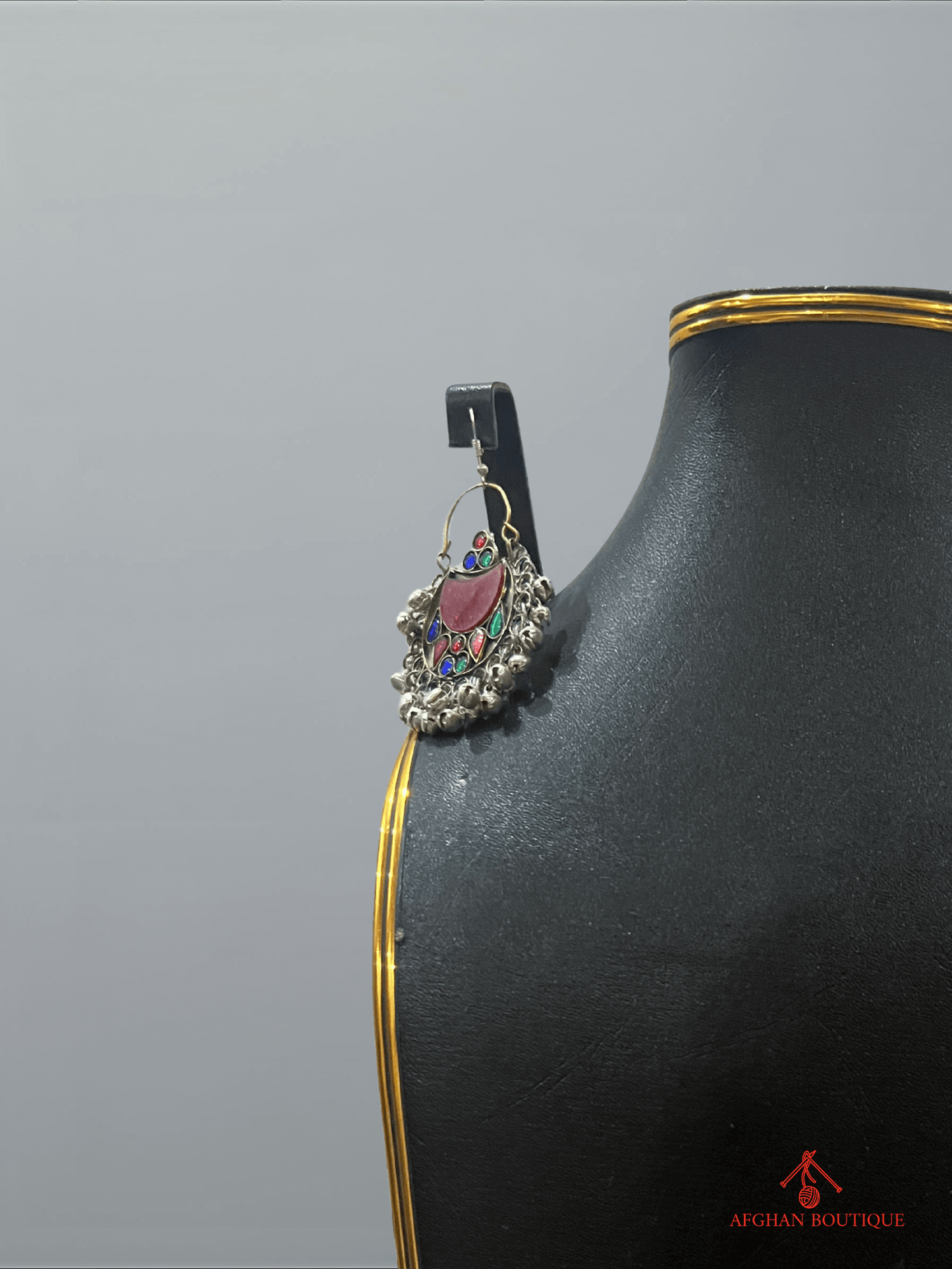 Close-up of right multicolor handcrafted Afghan earring featuring colorful gemstones and artisan detailing.