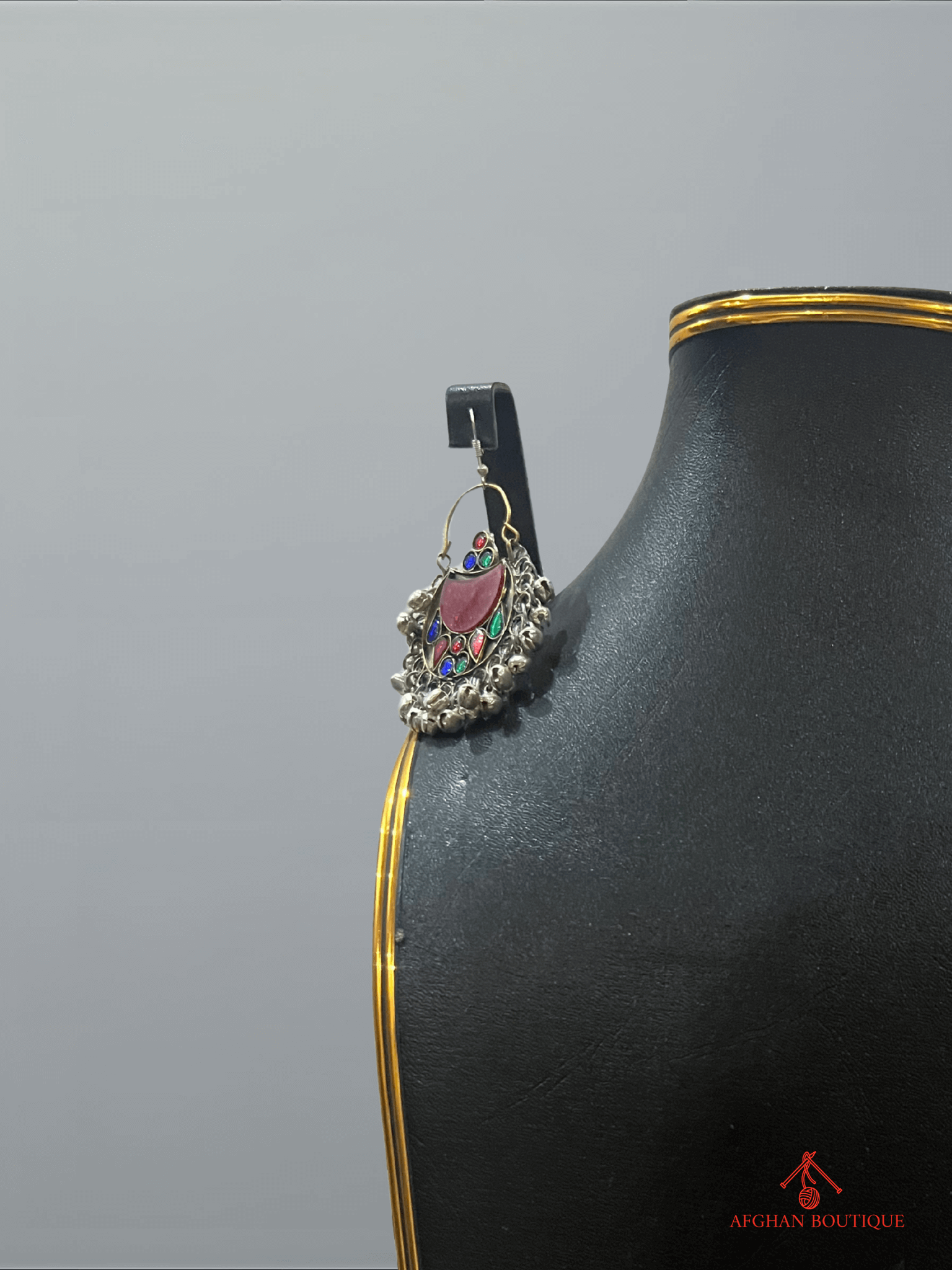 Close-up of right multicolor handcrafted Afghan earring featuring colorful gemstones and artisan detailing.