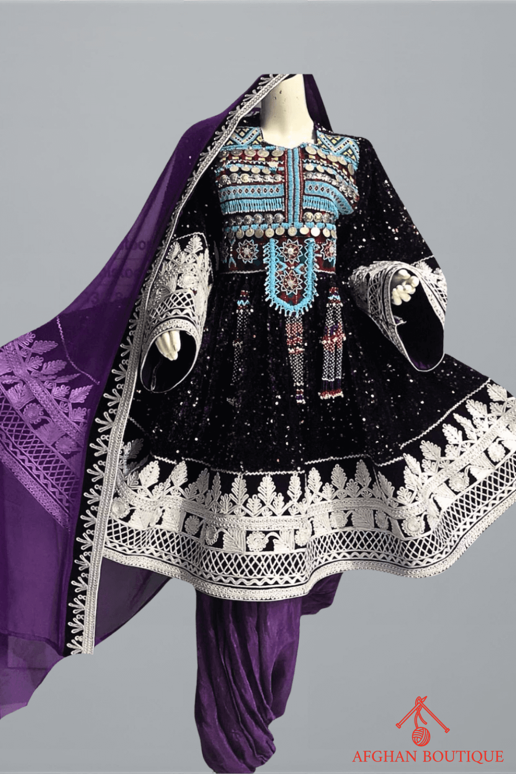 Front view of purple Afghani frock with white embroidery work
