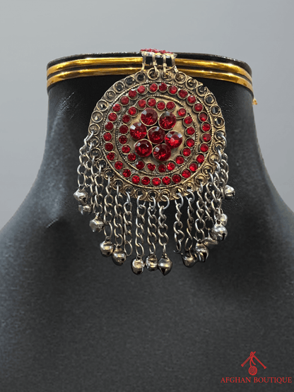 Close-up of handcrafted red Afghan headpiece highlighting intricate detailing and cultural patterns.